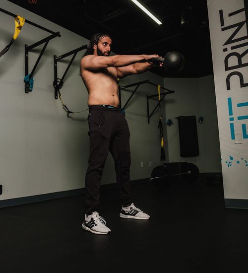 Athlete focused during a workout, demonstrating concentration and power.